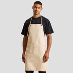 Model wearing the Premier 'Artisan's Choice' Double Pocket Canvas Apron PR181 in Natural.