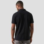 Rear view of model wearing the Orn Eagle Polo Shirt 1150 in black