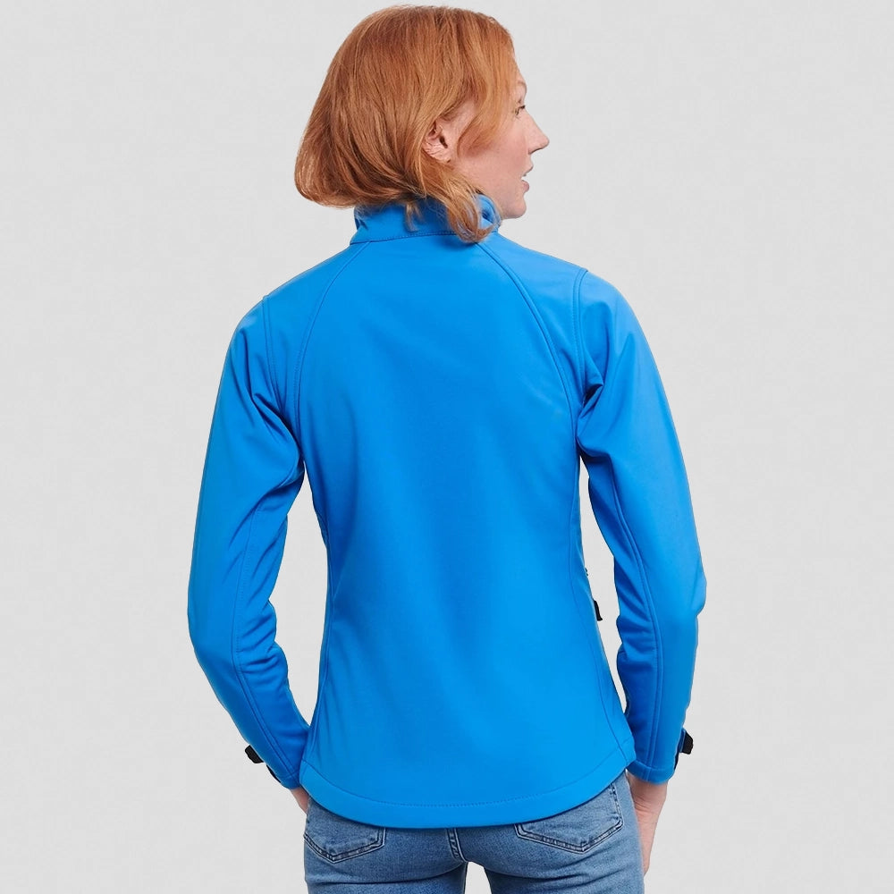 A back view of a model wearing a Russell Ladies Soft Shell Jacket