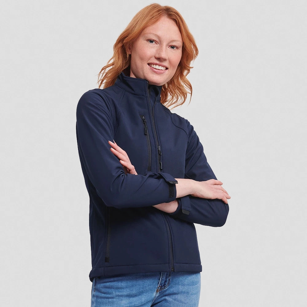 A model wearing a French navy Russell Ladies Soft Shell Jacket