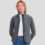 A model wearing a Titanium Russell Ladies Soft Shell Jacket