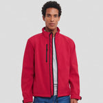 A model wearing a red Russell Soft Shell Jacket