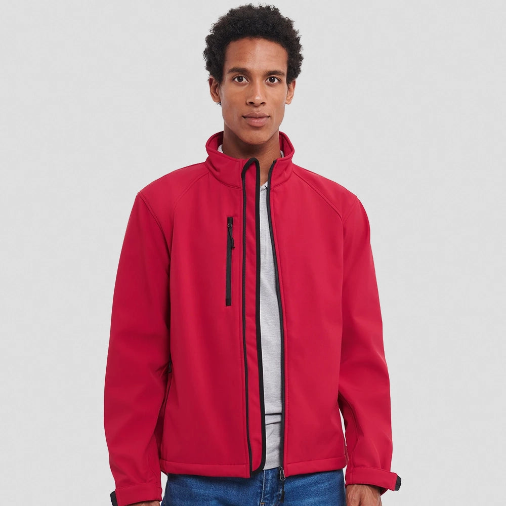 A model wearing a red Russell Soft Shell Jacket