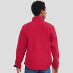 A model wearing a red Russell Soft Shell Jacket
