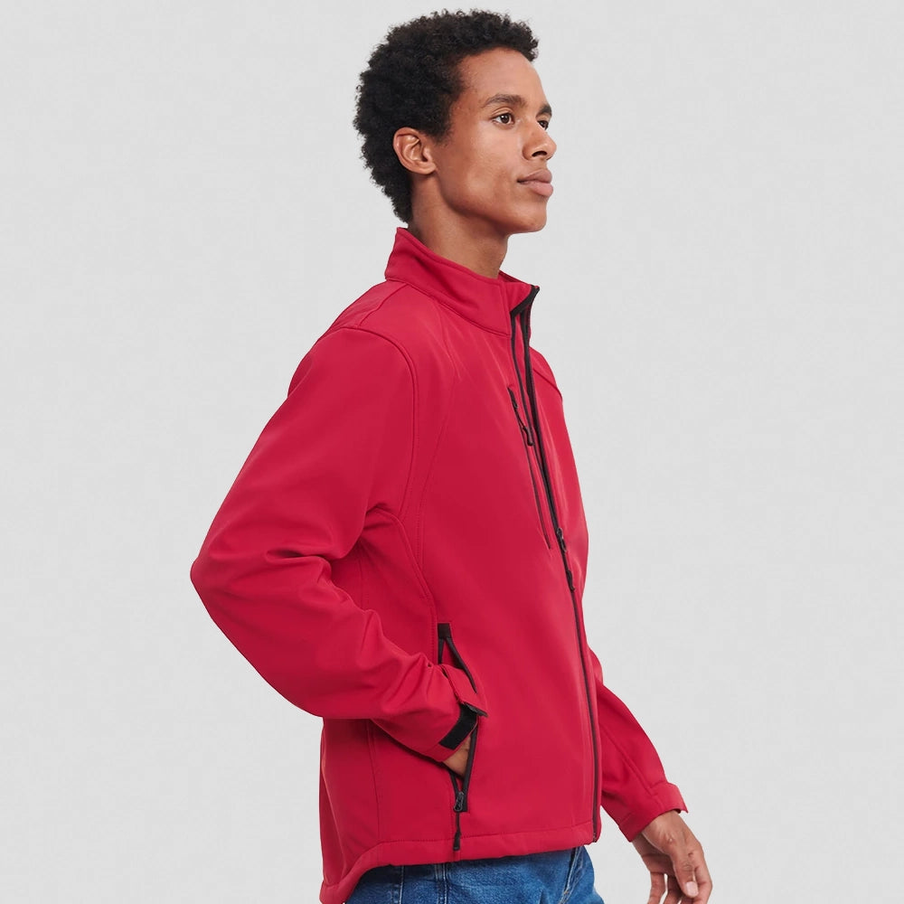 A side view of a model wearing a red Russell Soft Shell Jacket
