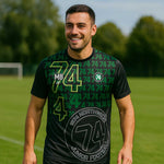 model wearing 1874 Northwich JFC T-Shirt – Adult on a sunny sports field 