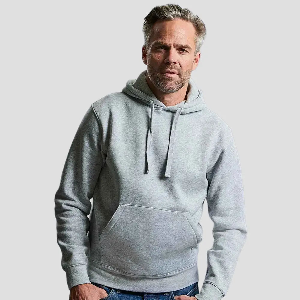 Model wearing the Russell Authentic Hooded Sweatshirt 265M in Heather Grey 