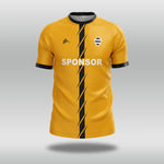 Yellow football shirt with black accents and a sponsor logo on a gray background
