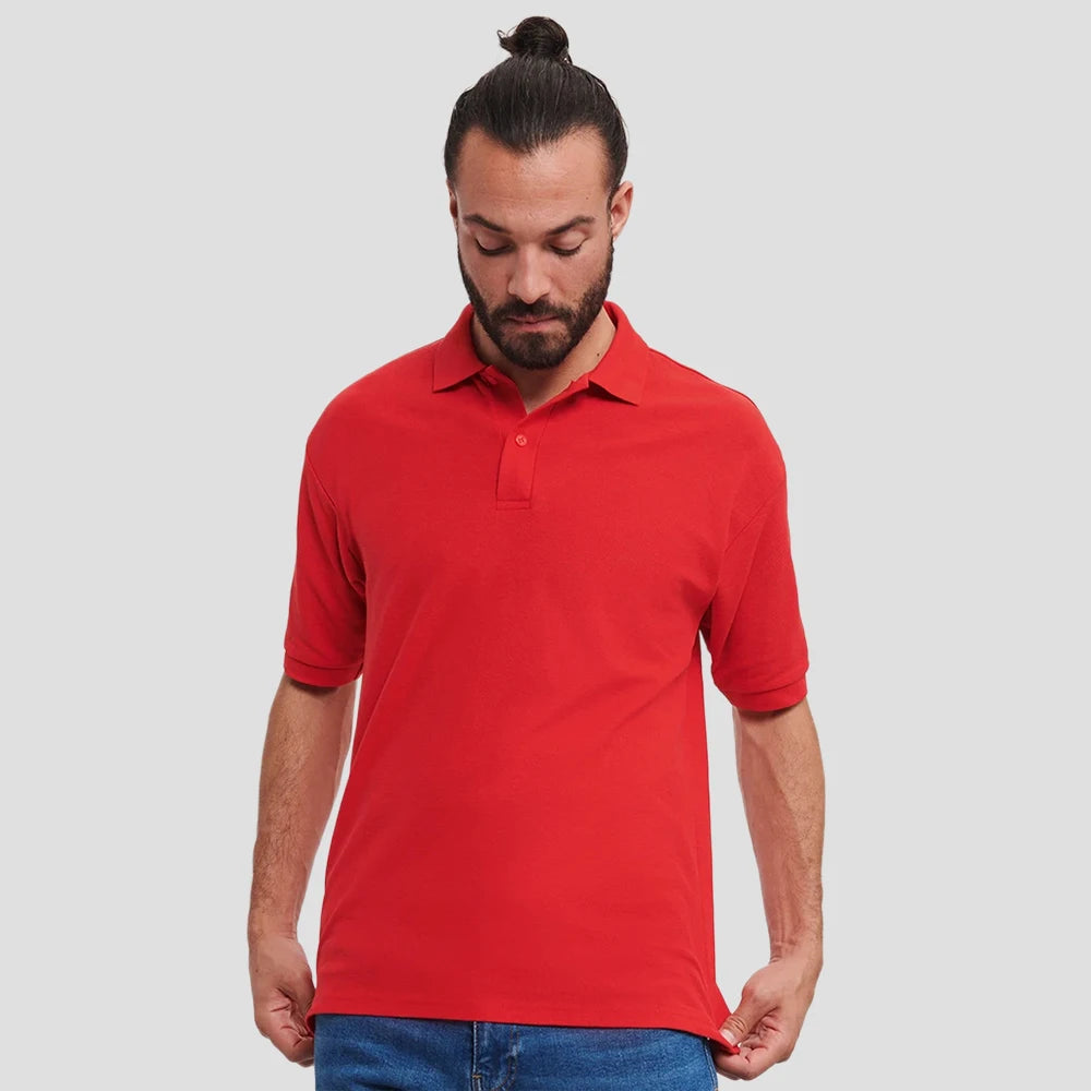 Model wearing the Russell Poly/Cotton Piqué Polo Shirt (Colours) 539M in Bright Red