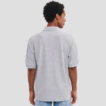 Model wearing the Russell Poly/Cotton Piqué Polo Shirt in Light Oxford