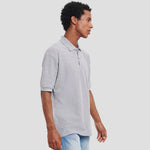 Model wearing the Russell Poly/Cotton Piqué Polo Shirt in Light Oxford