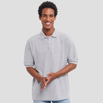 Model wearing the Russell Poly/Cotton Piqué Polo Shirt in Light Oxford