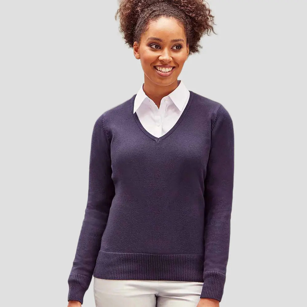 Model wearing the Russell Collection Ladies Cotton Acrylic V Neck Sweater 710F in Navy