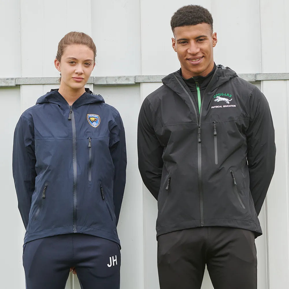 Two models wearing branded technical jackets, navy and black