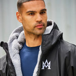 model wearing Weatherproof Changing Robe (911) navy with fleecy hood lining