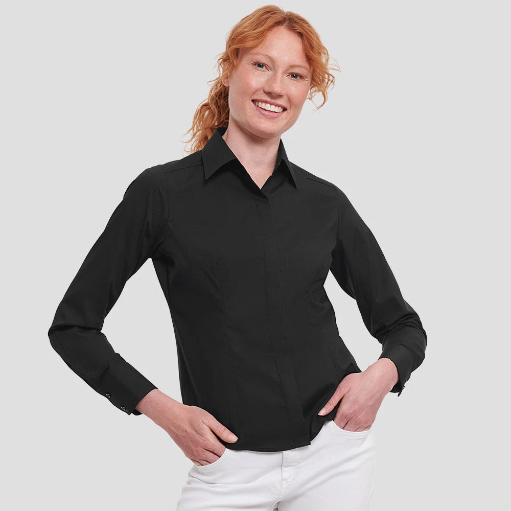 Model wearing the Russell Collection Ladies Long Sleeve Fitted Poplin Shirt 924F in Black