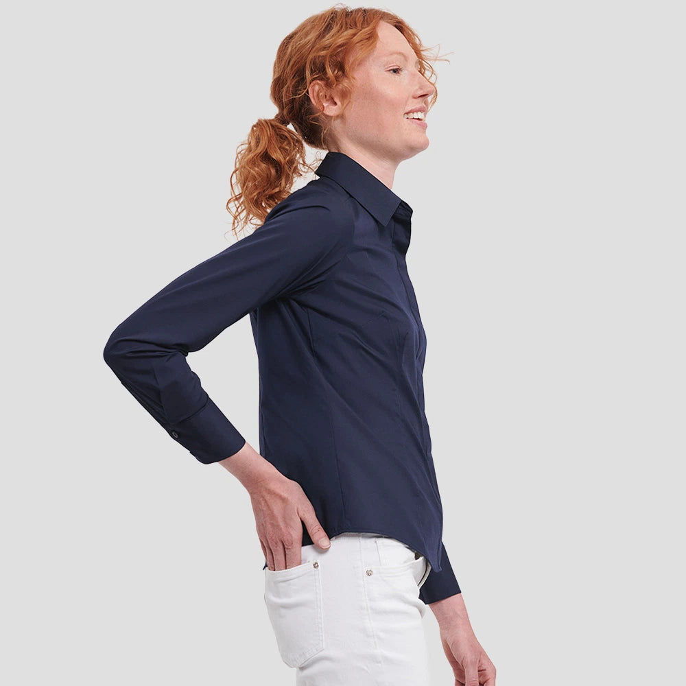Side view of Model wearing the Russell Collection Ladies Long Sleeve Fitted Poplin Shirt 924F in French Navy