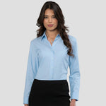 Model wearing the Russell Collection Ladies Long Sleeve Easy Care Oxford Shirt 932f in Oxford Blue
