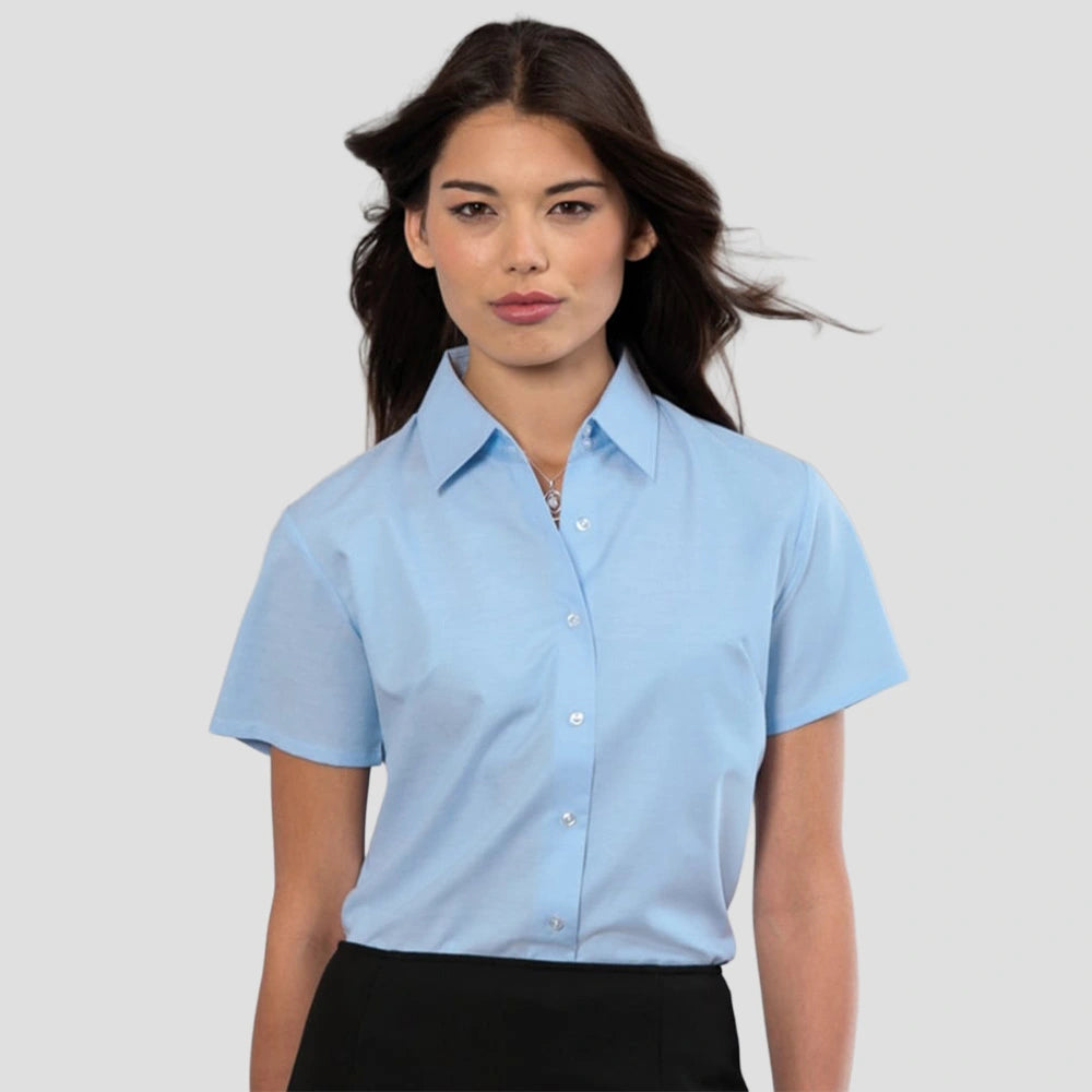 Model wearing the Russell Collection Ladies Short Sleeve Easy Care Oxford Shirt 933F in Oxford Blue