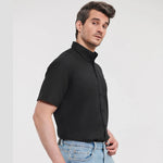 Model wearing the Russell Collection Short Sleeve Easy Care Oxford Shirt 933M in Black