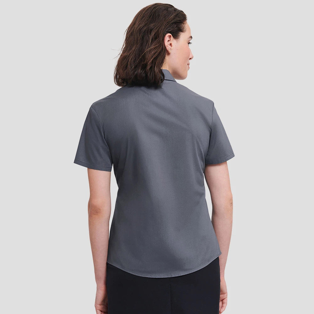 Rear view of Model wearing the Russell Collection Ladies Short Sleeve Easy Care Poplin Shirt 935F in Convoy Grey
