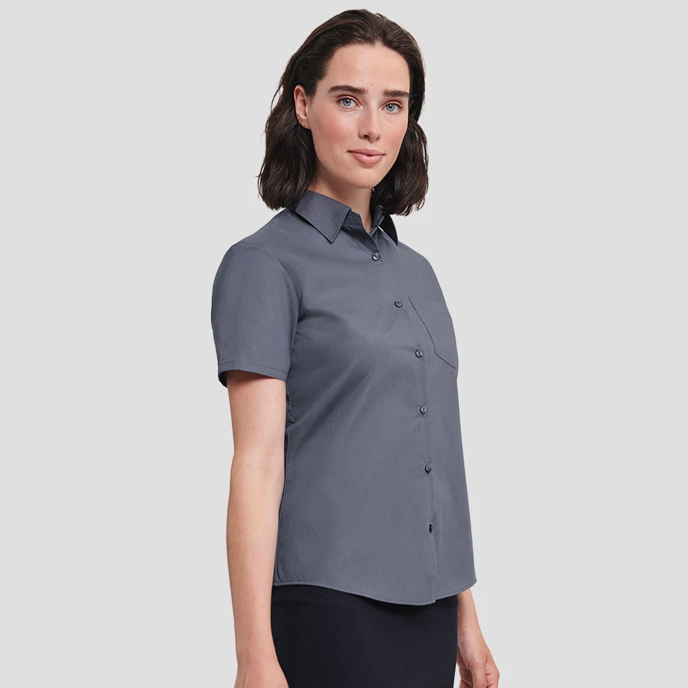 Model wearing the Russell Collection Ladies Short Sleeve Easy Care Poplin Shirt 935F in Convoy Grey