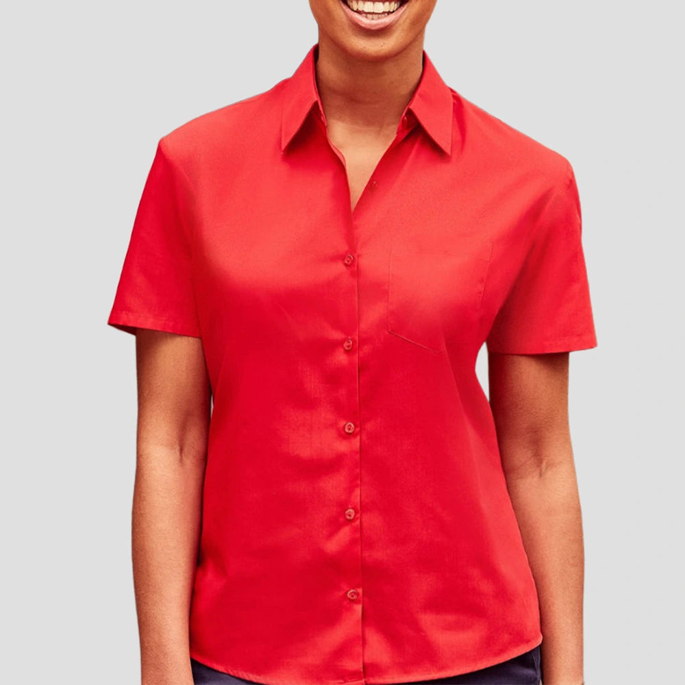 Model wearing the Russell Collection Ladies Short Sleeve Easy Care Poplin Shirt 935F in Red