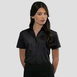 Model wearing the Russell Collection Ladies Short Sleeve Easy Care Poplin Shirt 935F in Black