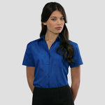 Model wearing the Russell Collection Ladies Short Sleeve Easy Care Poplin Shirt 935F in Bright Royal