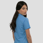 Rear view of model wearing the Russell Collection Ladies Short Sleeve Easy Care Poplin Shirt 935F in Corporate Blue