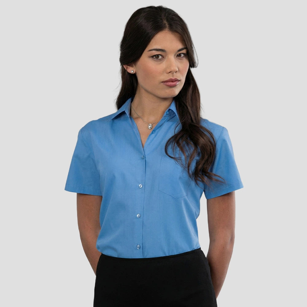 Model wearing the Russell Collection Ladies Short Sleeve Easy Care Poplin Shirt 935F in Corporate Blue