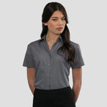 Model wearing the Russell Collection Ladies Short Sleeve Easy Care Poplin Shirt 935F in Convoy Grey