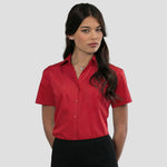 Model wearing the Russell Collection Ladies Short Sleeve Easy Care Poplin Shirt 935F in Classic Red