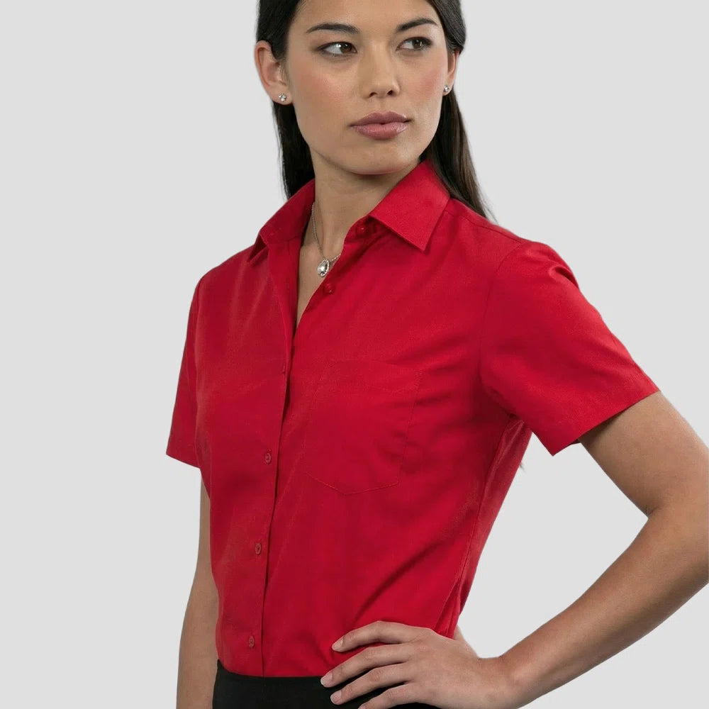 Model wearing the Russell Collection Ladies Short Sleeve Easy Care Poplin Shirt 935F in Red