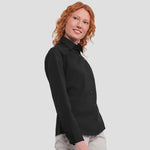 Model wearing the Russell Collection Ladies Long Sleeve Easy Care Cotton Poplin Shirt 936F in Black