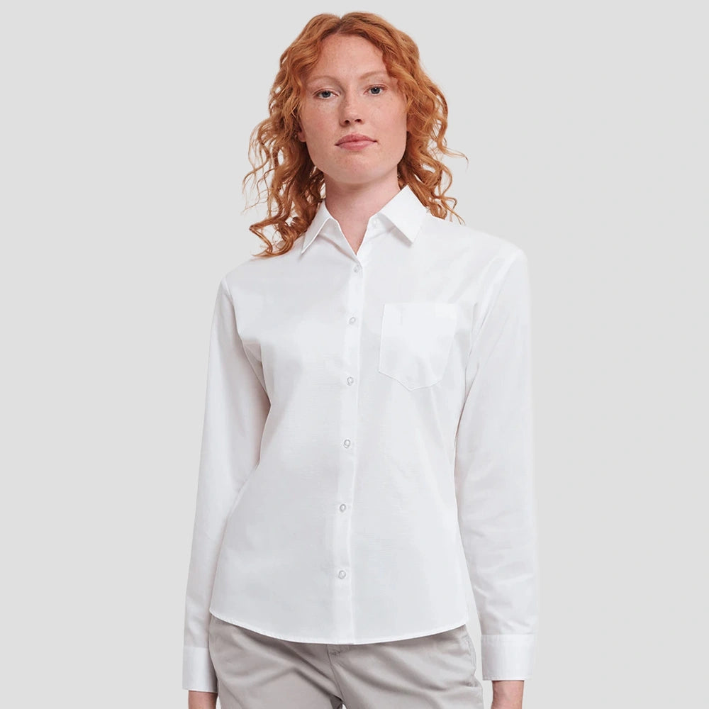 Model wearing the Russell Collection Ladies Long Sleeve Easy Care Cotton Poplin Shirt 936F in White