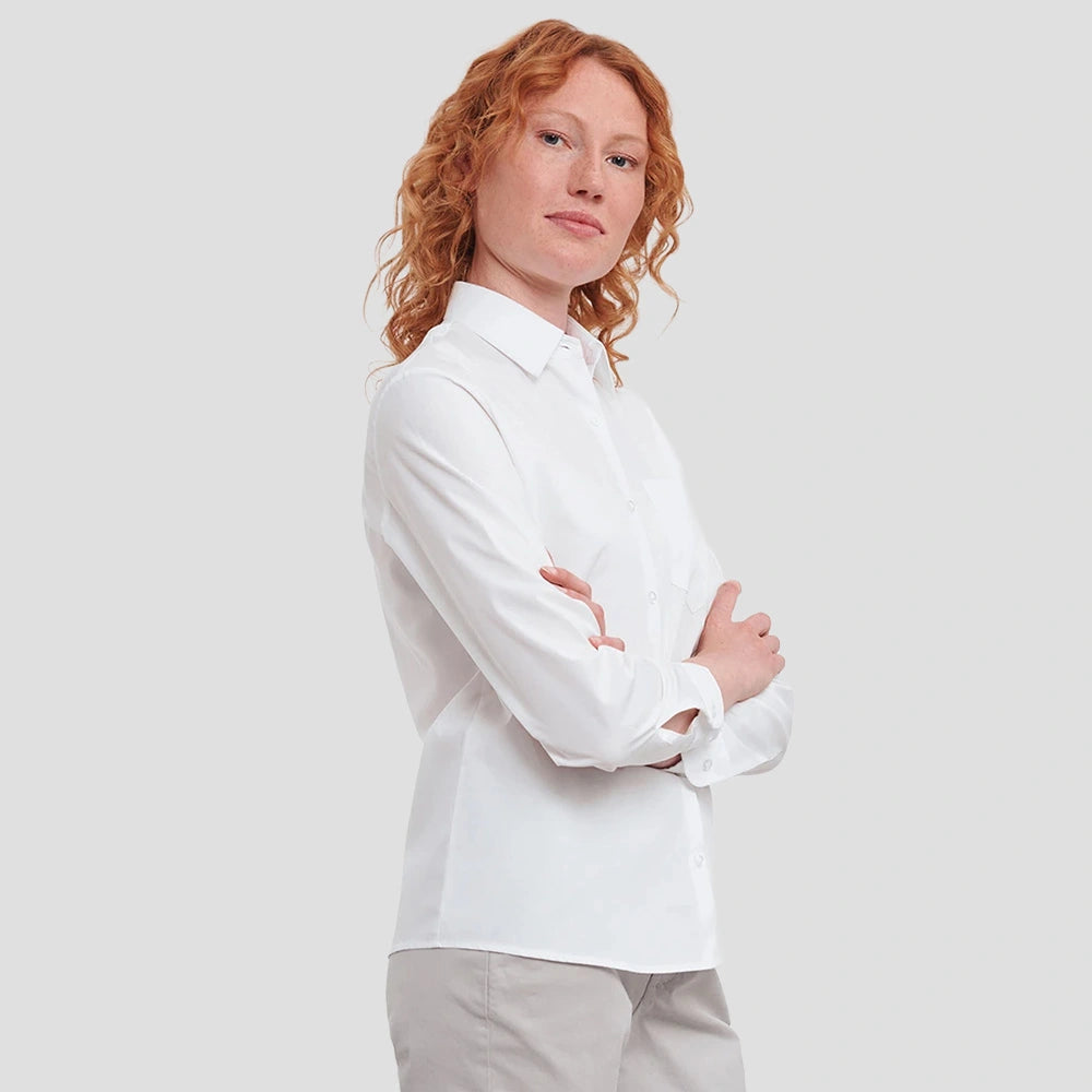 Model wearing the Russell Collection Ladies Long Sleeve Easy Care Cotton Poplin Shirt 936F in White
