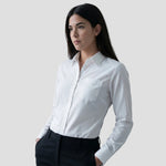 Model wearing the Russell Collection Ladies Long Sleeve Easy Care Cotton Poplin Shirt 936F in White