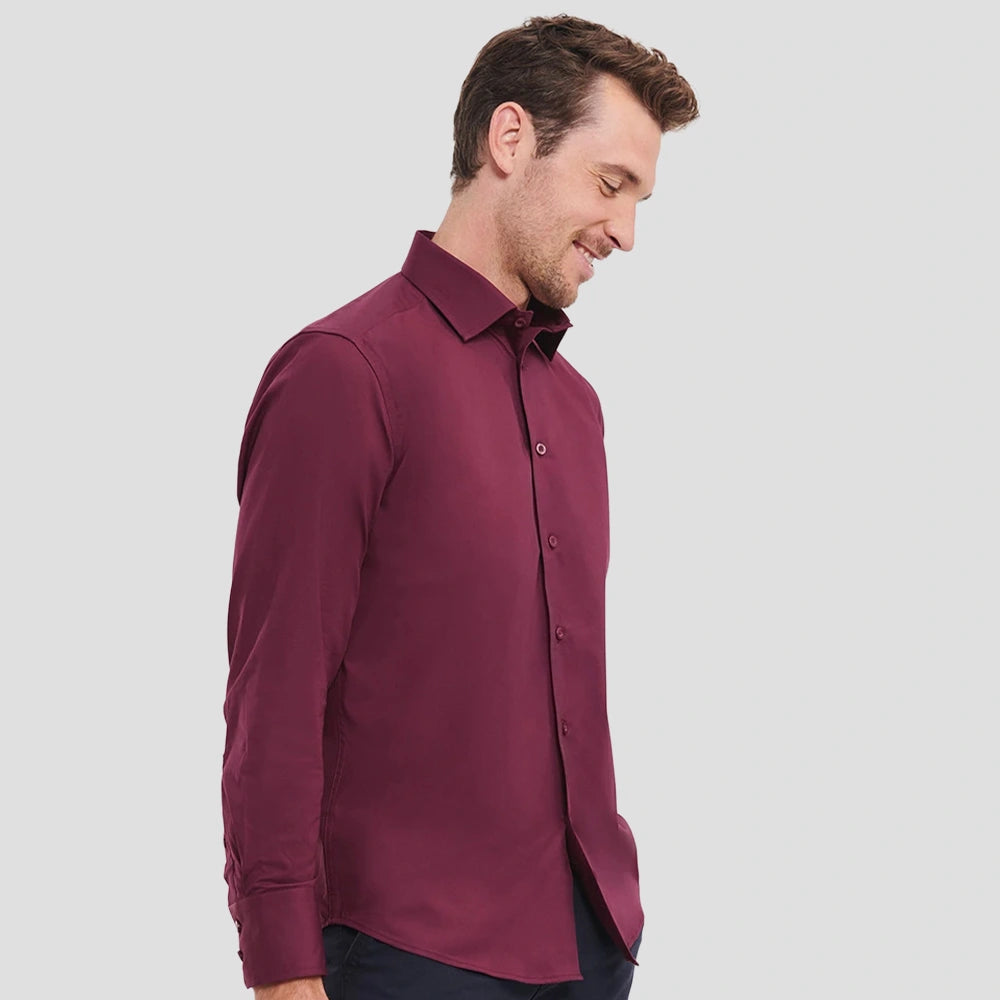 Side view of Model wearing the Russell Collection Long Sleeve Easy Care Fitted Shirt 946M in Port