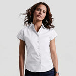 Model wearing the Russell Collection Ladies Short Sleeve Easy Care Fitted Shirt 947F in White