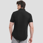 Rear view of Model wearing the Russell Collection Short Sleeve Easy Care Fitted Shirt 947M in Black