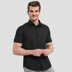 Model wearing the Russell Collection Short Sleeve Easy Care Fitted Shirt 947M in Black