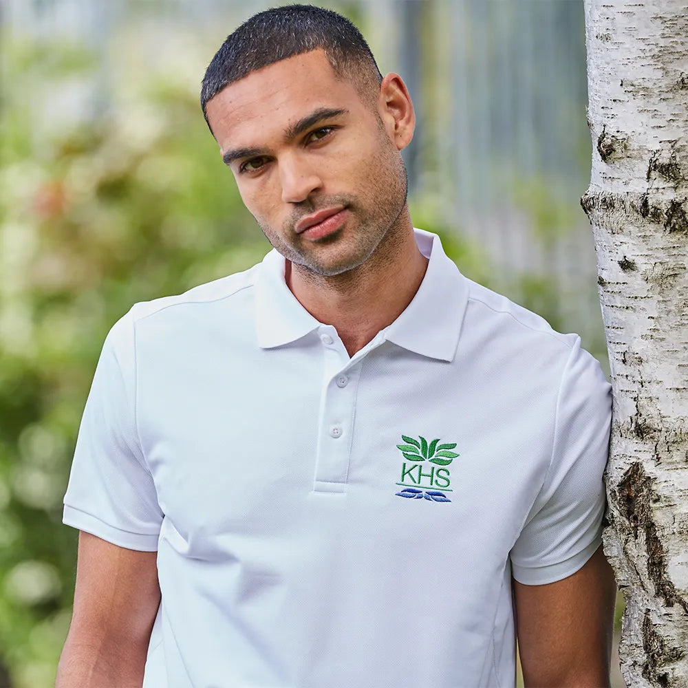 model wearing Classic Technical Polo in white with team crest embroidered on chest
