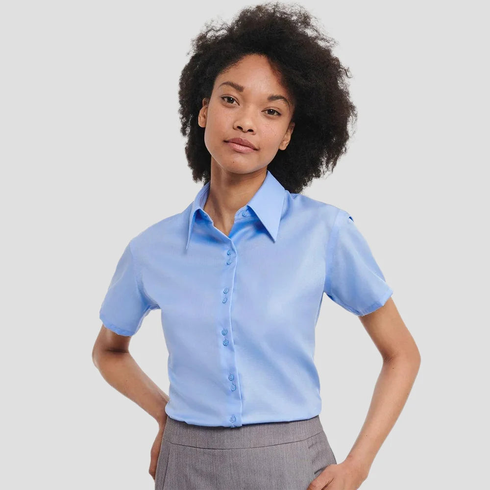 Model wearing the Russell Collection Ladies Short Sleeve Ultimate Non-Iron Shirt in Bright Sky