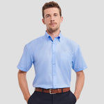 Model wearing the Russell Collection Short Sleeve Ultimate Non-Iron Shirt 957M in Bright Sky Blue