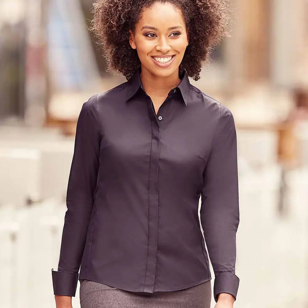 Model wearing the Russell Collection Ladies Ultimate Stretch Shirt in Black
