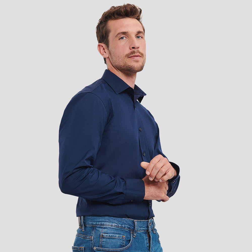 Model wearing the Russell Collection Long Sleeve Ultimate Stretch Shirt 960M in Bright Navy