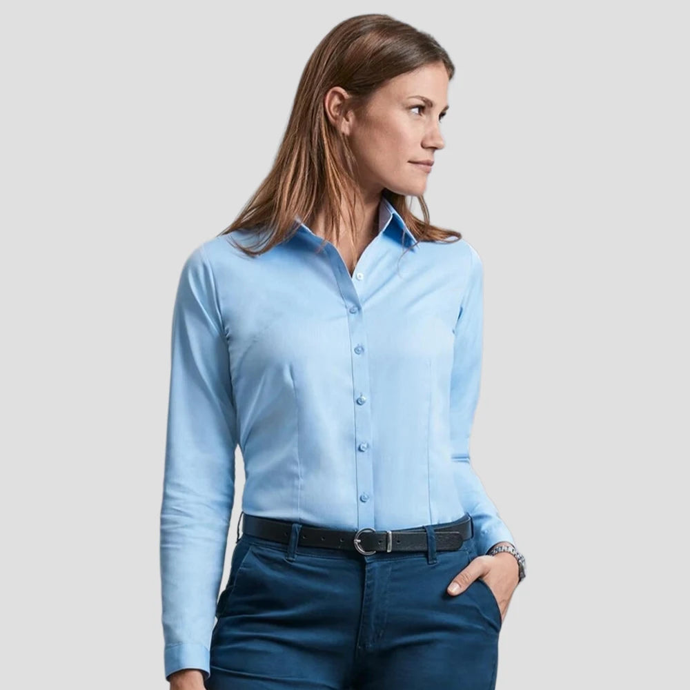 Model wearing the Russell Collection Ladies Long Sleeve Herringbone Shirt 962F in Light Blue