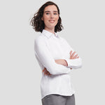 Model wearing the Russell Collection Ladies Long Sleeve Herringbone Shirt in White