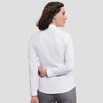 Rear view of Model wearing the Russell Collection Ladies Long Sleeve Herringbone Shirt in White